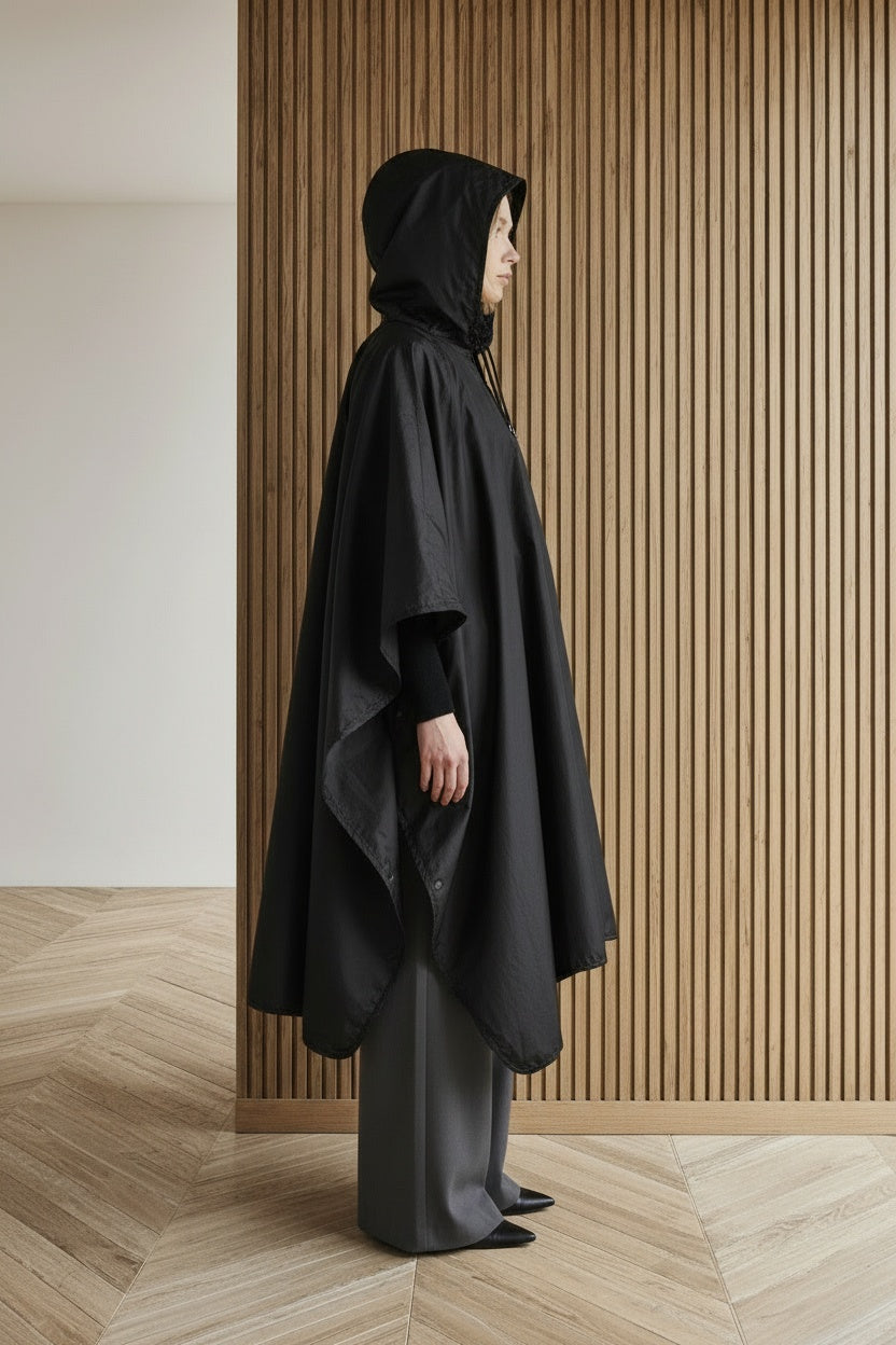 Side profile of the model wearing Ultra-Light Waterproof Poncho | Compact Rain Protection