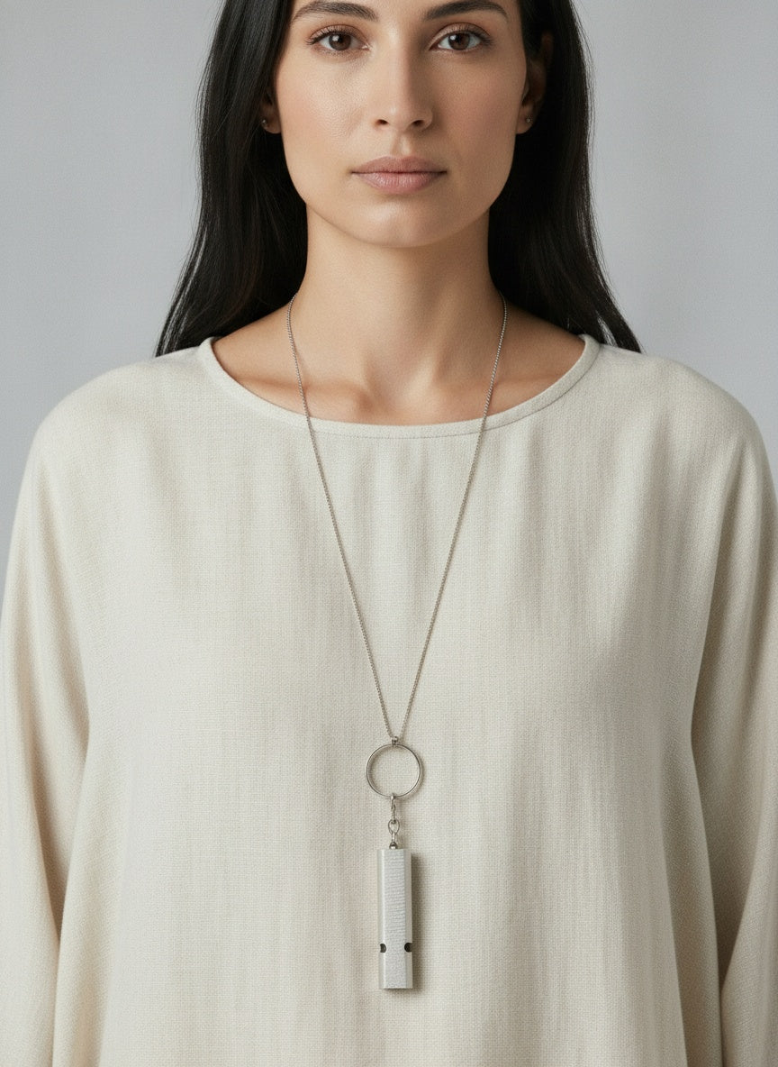 Close-up of the model wearing Emergency Whistle Keychain